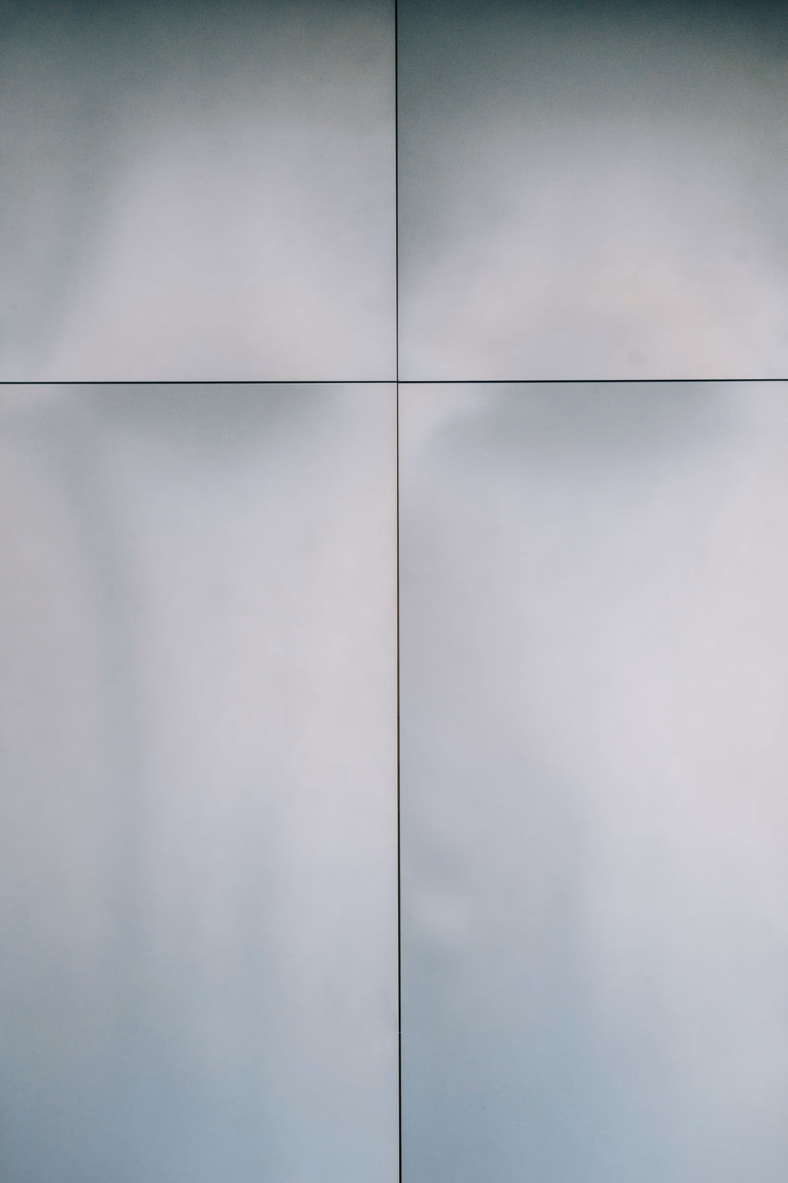 Translucent panels in graded whites across a north elevation