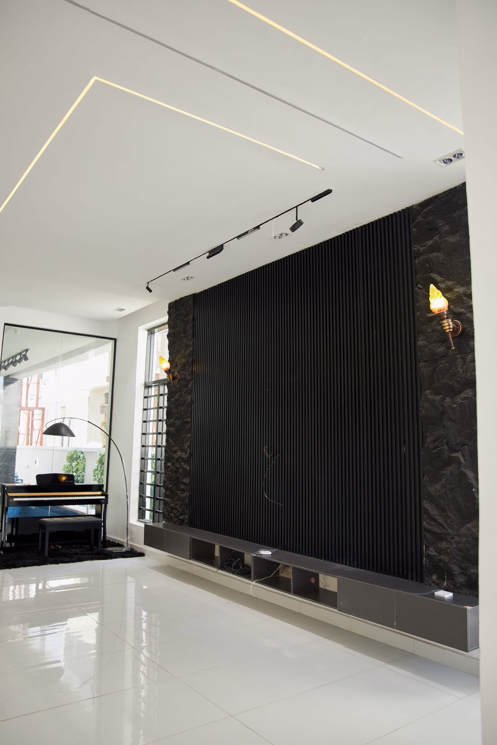 Shooting floor with a full-height dark marble wall and a polished screed underfoot