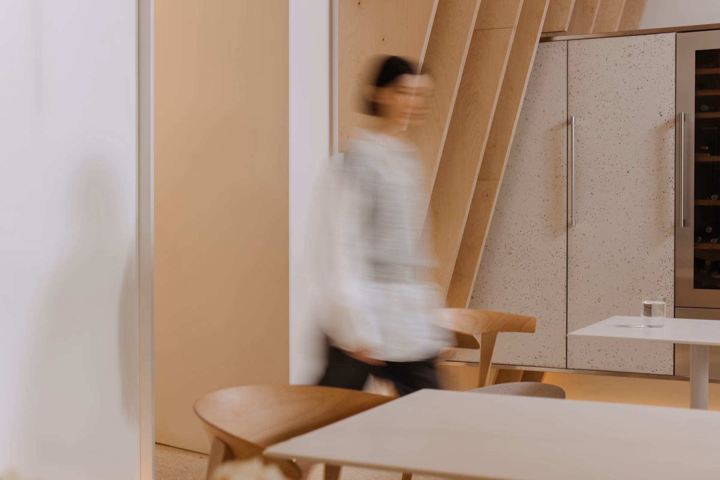 The Ruang Rasa atelier, a member of the studio crossing the workspace under north light